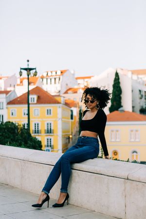 Fashionable Black female relaxing in city