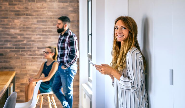 Happy businesswoman looking at camera in office
