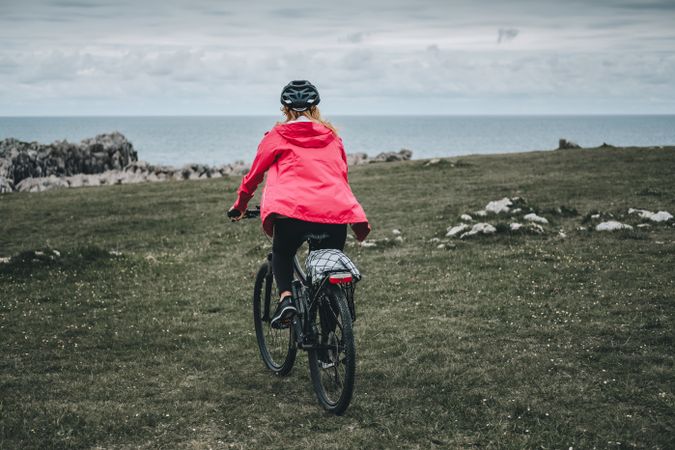 Female cyclist riding on mountain road