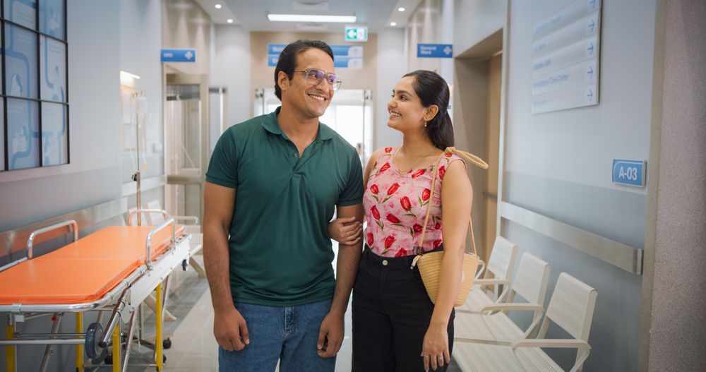 Portrait of Young Indian Couple in a Hospital Smiling and Looking at the Camera.