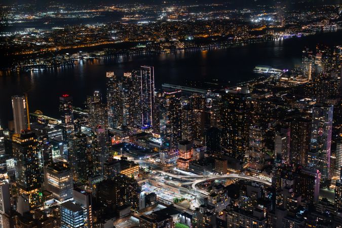 Aerial View of Manhattan Architecture at Night. Night Photo of Financial Business District from a Helicopter. Scenery of Historic Office Towers, Illuminated Skyscrapers