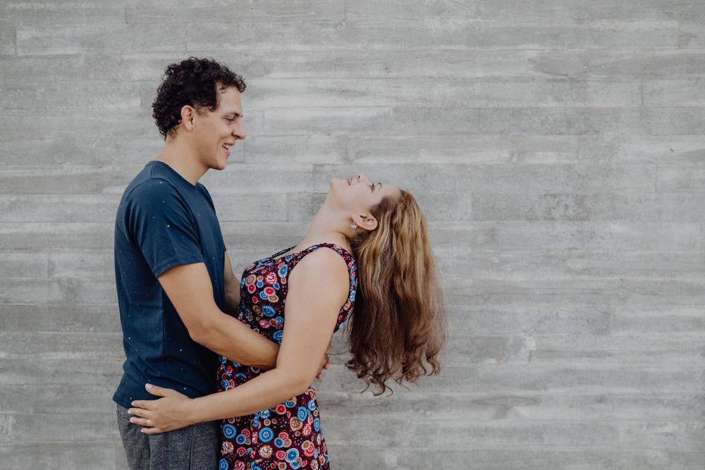 man and woman hugging at nearby street wall