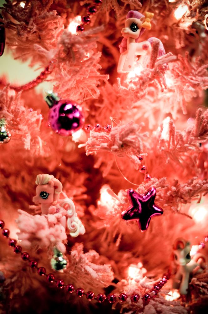 Artificial pink festive tree with lights and ornaments