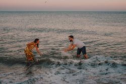 Active lovely couple having fun in foamy water
