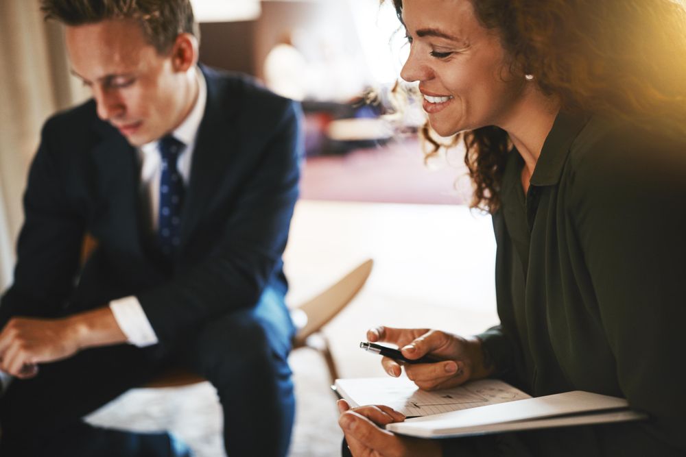 Man and woman with notepad