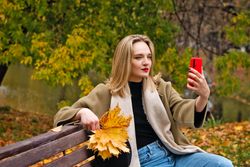 Woman on park bench in autumn