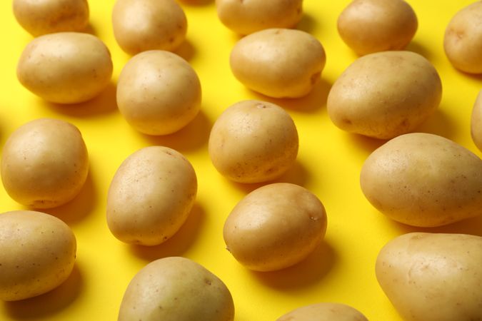 Close up of potatoes on yellow background