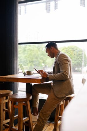 Man working on laptop at cafeteria