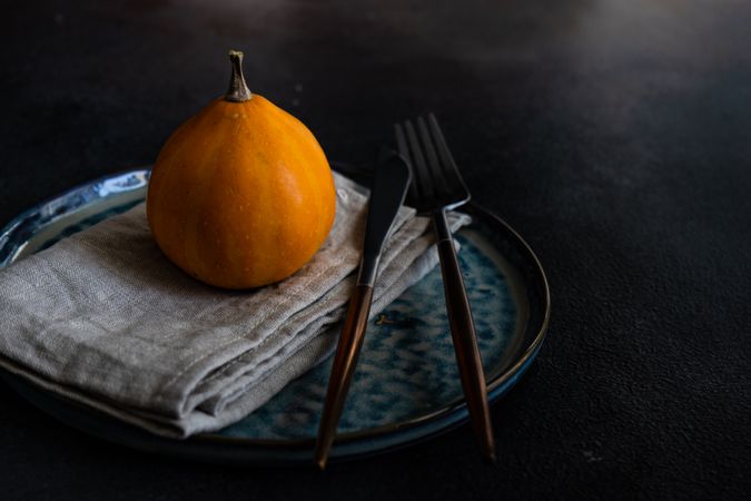 Single squash in elegant decorative autumnal table setting