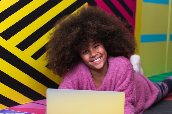 Black girl using laptop in studio