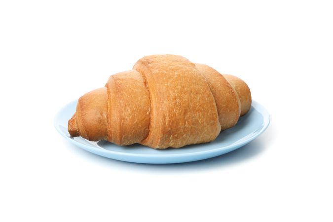 Plate with croissant isolated on plain background