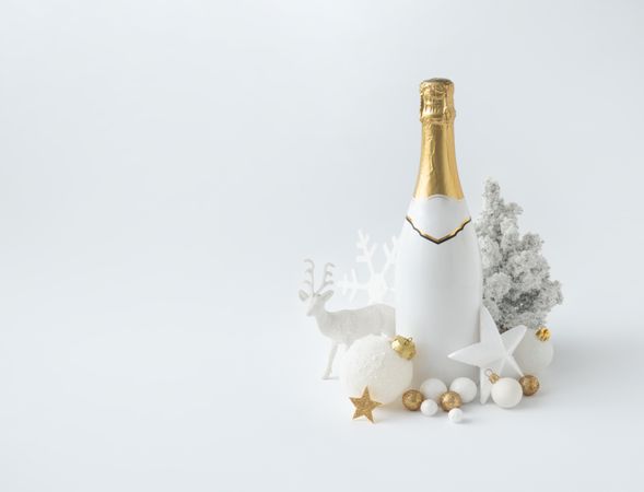 Champagne bottle and golden Christmas decoration on  background