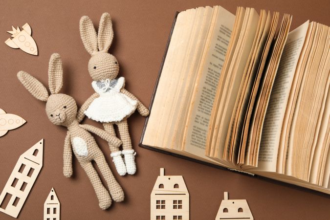 A children's book with toys on a beige background.