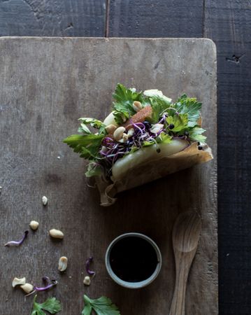 Served Gua Bao sandwich with sauce on board