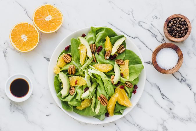 Served avocado and orange with pecan