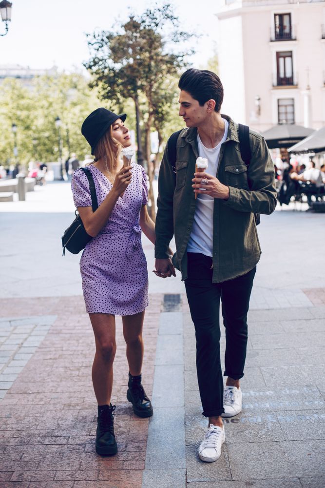 Happy couple walking in the street with ice-creams
