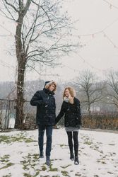 Smiling couple holding hands while walking on the street