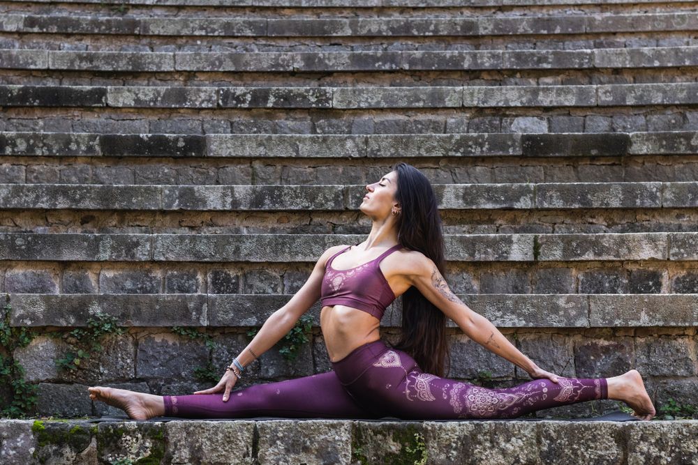 Slender woman doing yoga in Monkey Pose