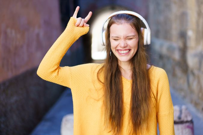 A Joyful Young Woman is Truly Enjoying Music in a Dynamic Urban Setting with Delight