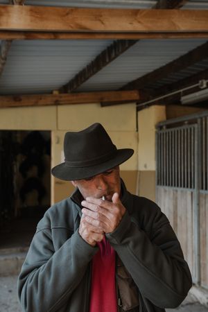 Man smoking in stable