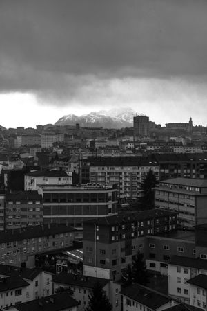 Modern buildings in city near mountains