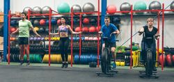Athletes doing air bike and skipping rope