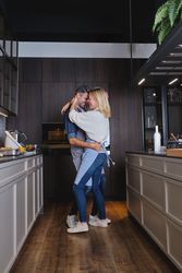Couple in love embracing and dancing in kitchen