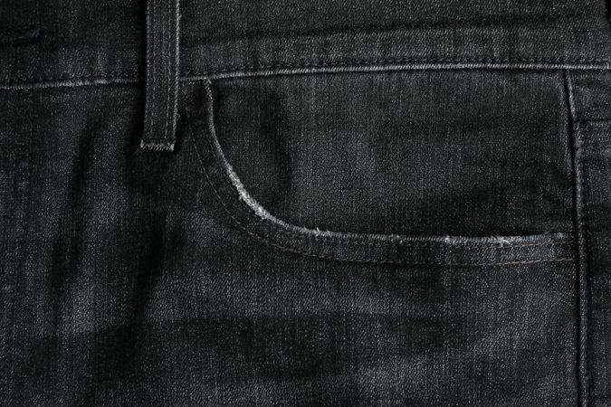 Closeup view of jeans pocket as background, space for text