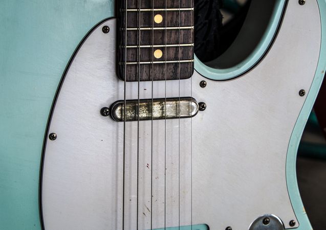 Close up of bridge of electric guitar