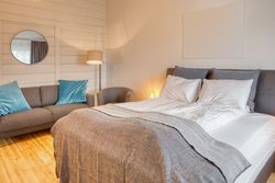 Cozy interior of bedroom with sofa