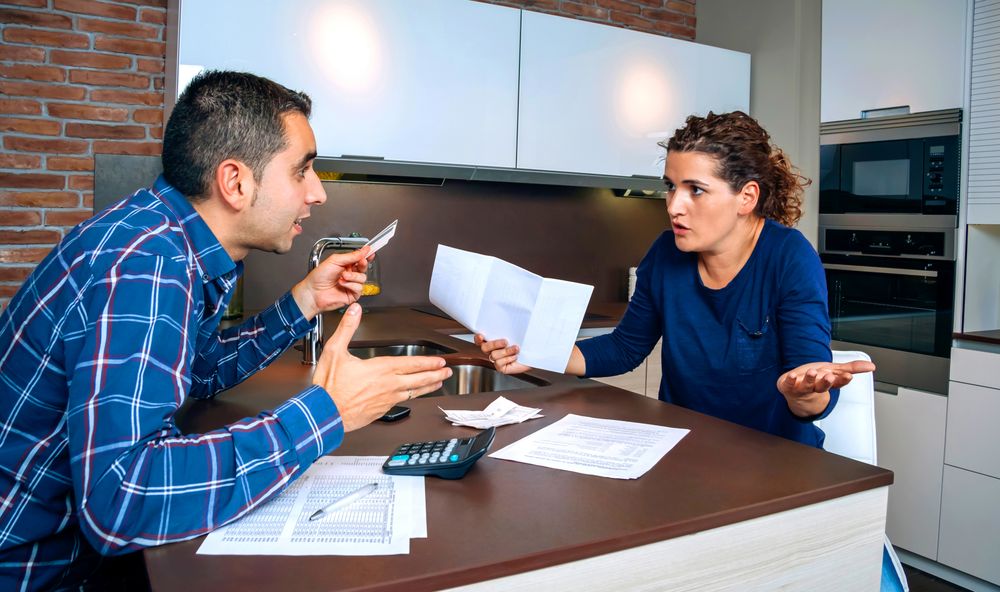 Man and woman arguing over bills