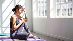 Woman using mobile phone to texting message on yoga mat