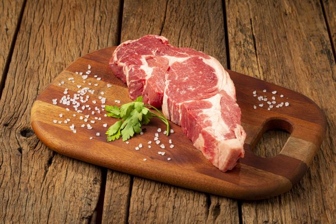 Raw ancho meat ready to roast on a wooden cutting board.