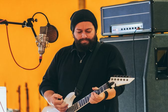 Musician playing guitar and singing