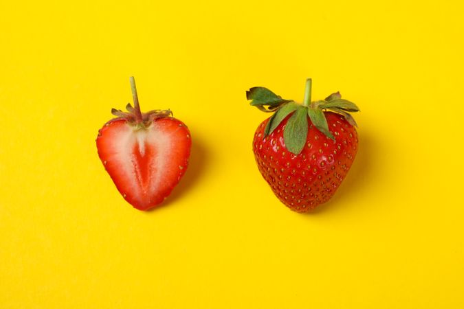 Tasty strawberry on yellow background. Summer berry
