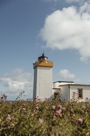 Lighthouse and buildings against sky