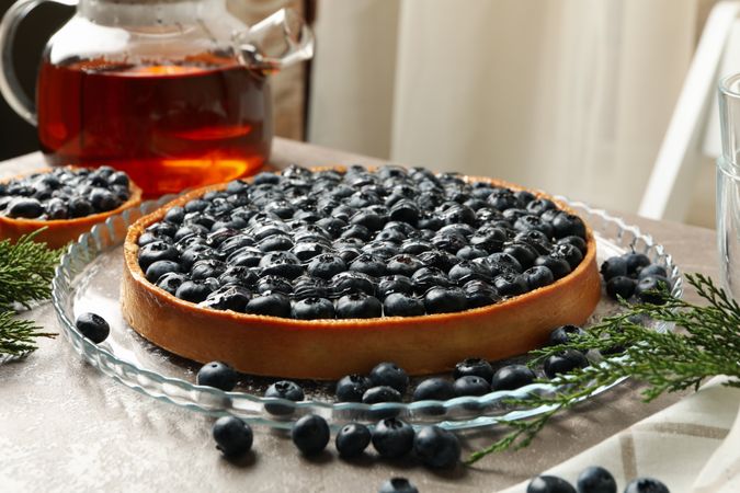 Concept of tasty lunch with blueberry pie on gray table
