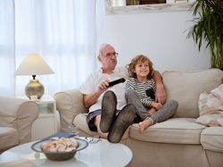 Grandfather with son watching TV