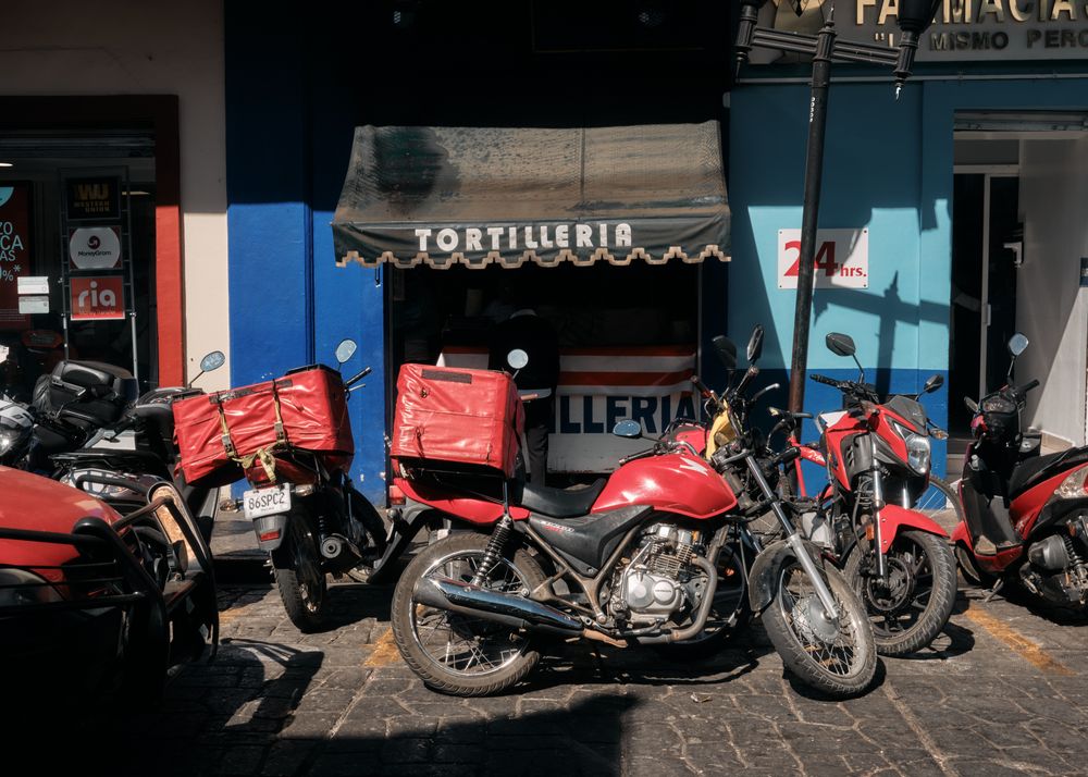 Awning of tortilleria with motorbikes parked outside