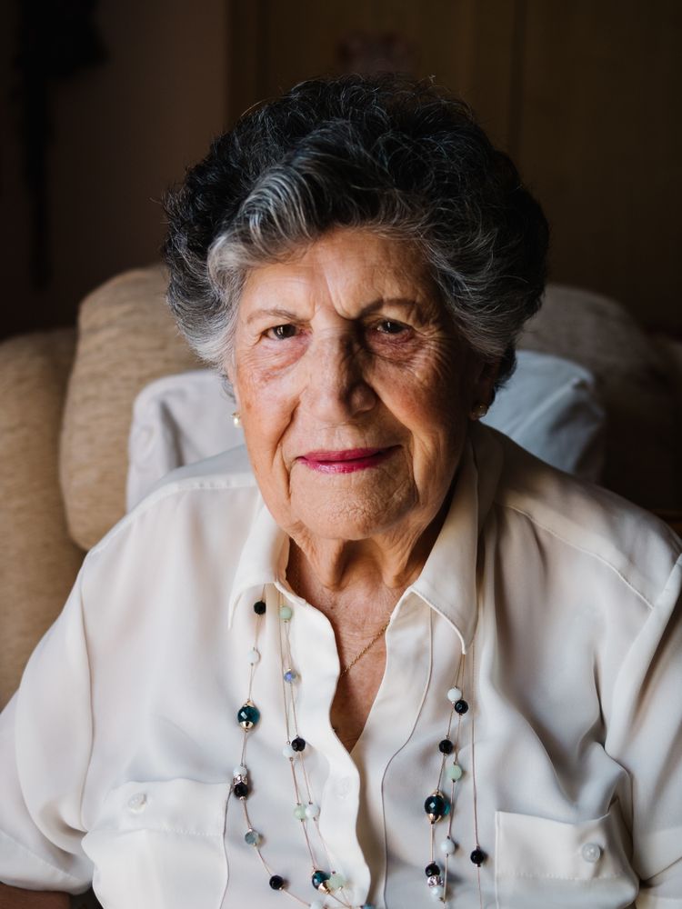 Portrait of mature female in white shirt at home