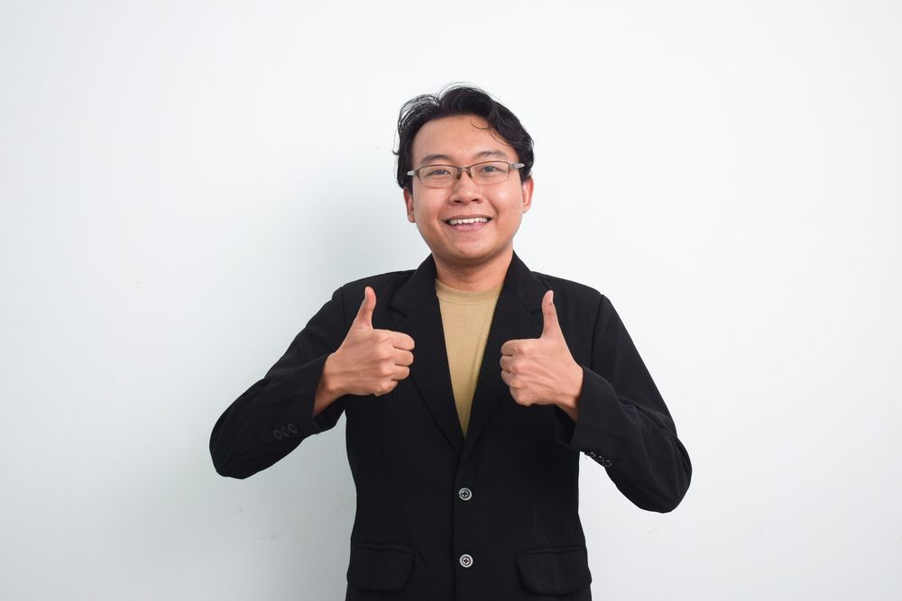 Asian Businessman doing ok agreement hand sign