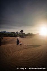 Person sitting on sand dunes of Oetune beach in East Nusa Tenggara, Indonesia 5zKkg4