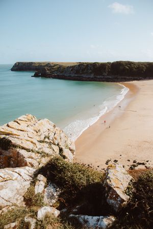 Sandy beach between long cliffs by sea