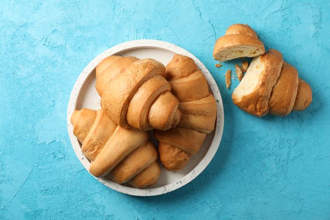 Tray with croissants on blue background