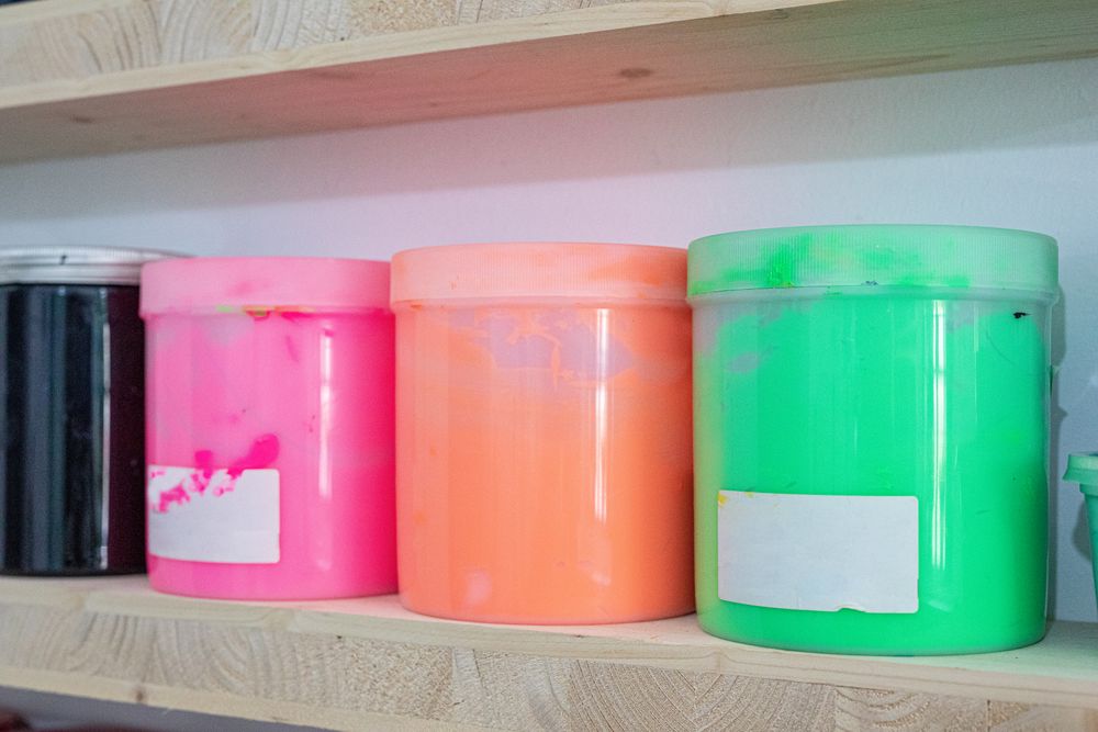 Shelves with colorful tins of paint