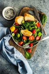 Fresh organic salad with spinach on wooden board