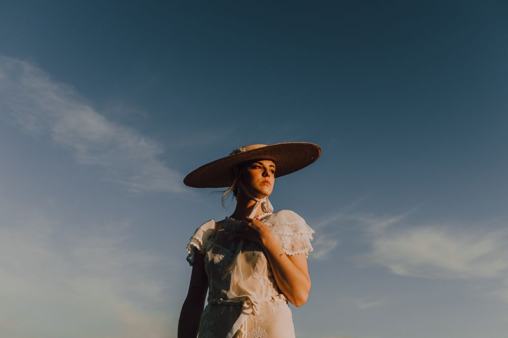 woman in hats in bright sunny day