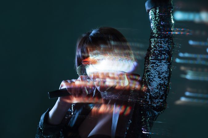 Stylish woman singing on stage