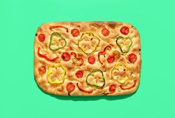 Vegan focaccia above view, minimalist on a green background
