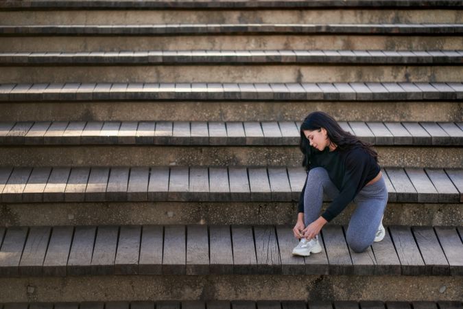 Young woman sitting on stairs